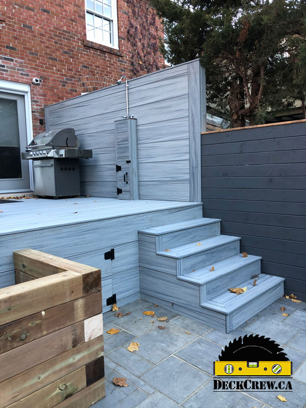 Composite deck with stairs, grill and a shower