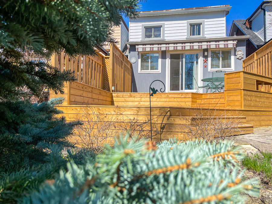 Golden-brown pressure treated deck is a great addition to any backyard