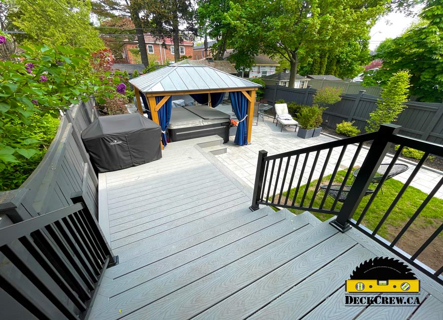 Grey multilevel composite decking and a hot tub