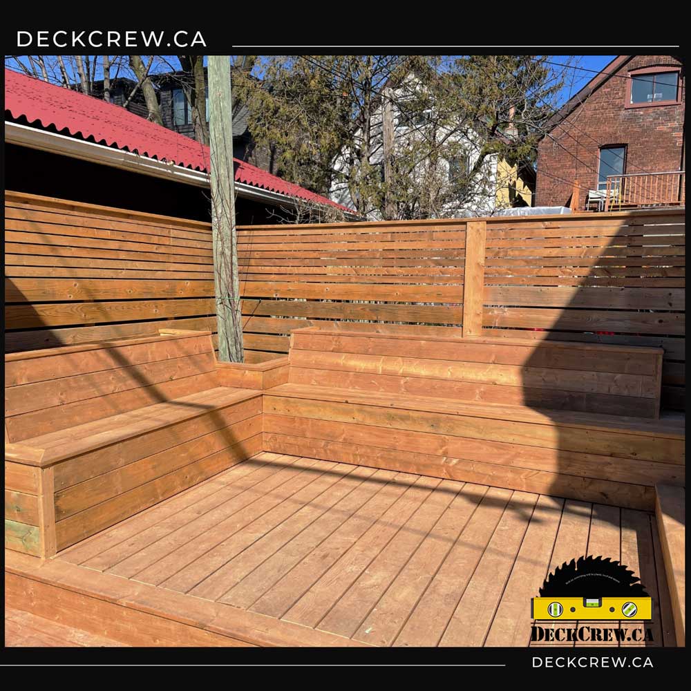 Pressure-treated decking with built-in furniture and privacy screen around