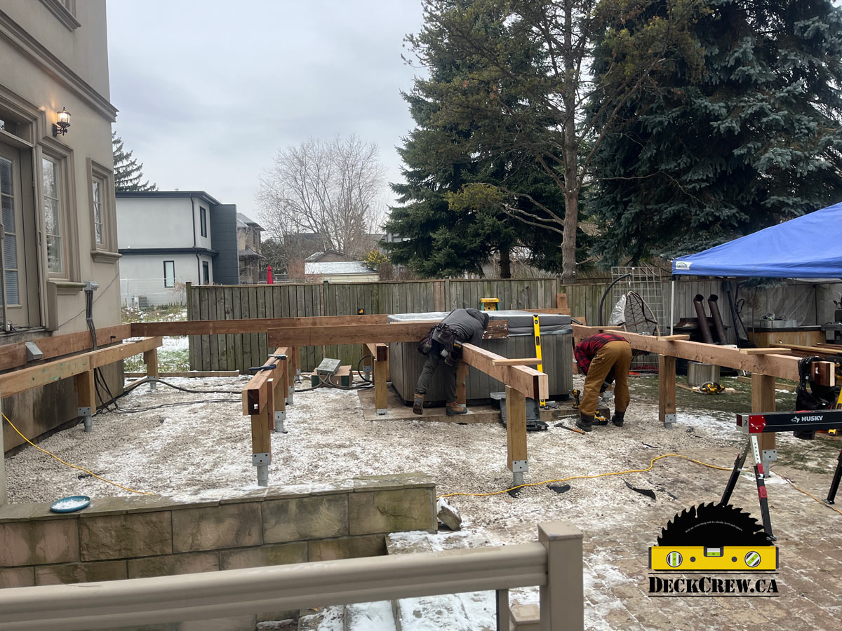 Helical piles and deck framing under construction in Lakeview Mississauga by DeckCrew